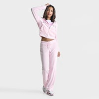 a woman in a pink tracksuit posing for a photo