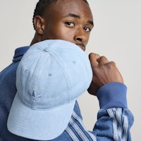 a man in a blue hat is posing for a photo