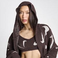 a woman wearing a brown hoodie