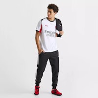 a man wearing a puma t - shirt and jogging pants