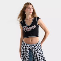 a woman wearing a black and white checkered crop top