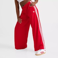 a woman in red adi pants posing for a photo