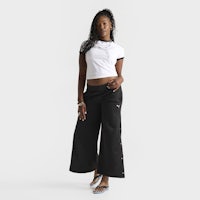 a woman wearing black wide leg pants and a white t - shirt