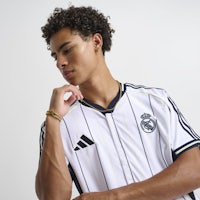 a young man wearing a real madrid jersey