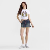 a woman wearing a white t - shirt and denim shorts