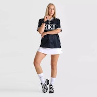 a woman in a black and white nike jersey posing for a photo